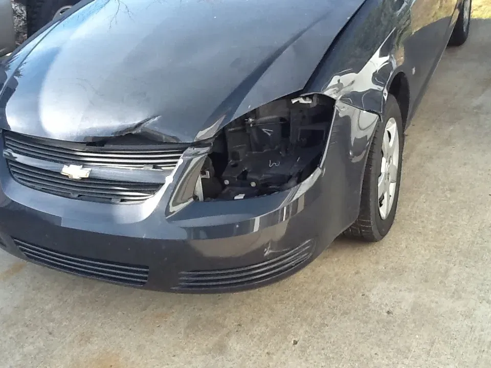 Damaged Chevrolet vehicle showing collision repair needs and auto body estimate.